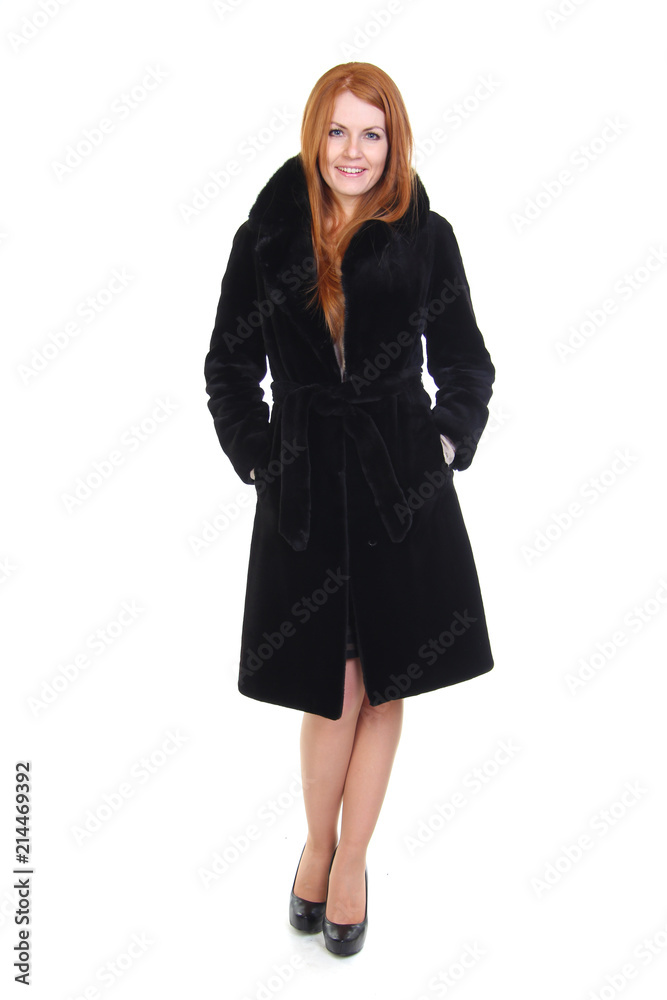 Redhead young woman in black fur coat isolated on white Redhead young woman in black fur coat isolated on white