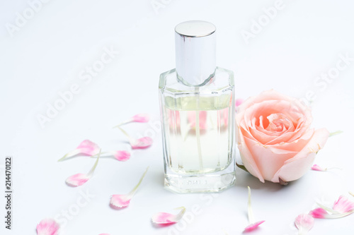 Perfume bottles and rose on white background