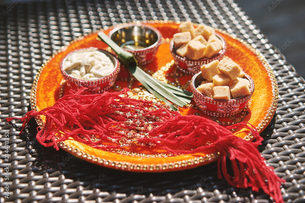 Indian wedding prayer items for thread ceremony, pooja (Puja), Selective focus on red thread and