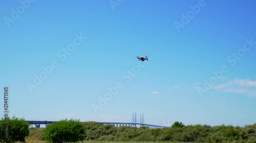 Drone flying in the blue with Oresund's bridge in Sweden in the background