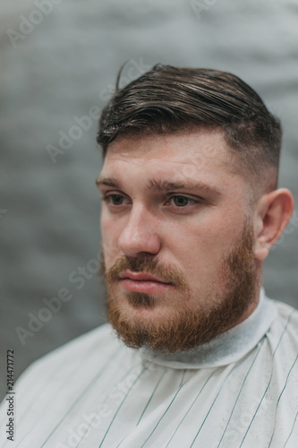 A man in a barber shop for haircuts and shaving
