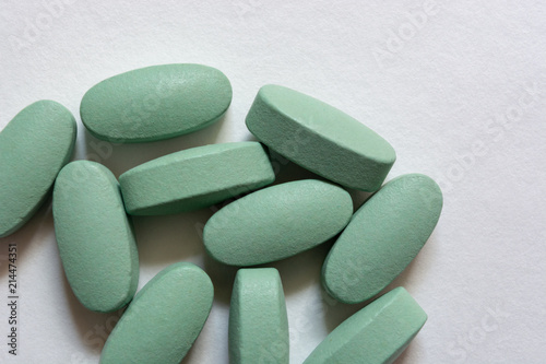 Close-up. Oval green tablets on a white background