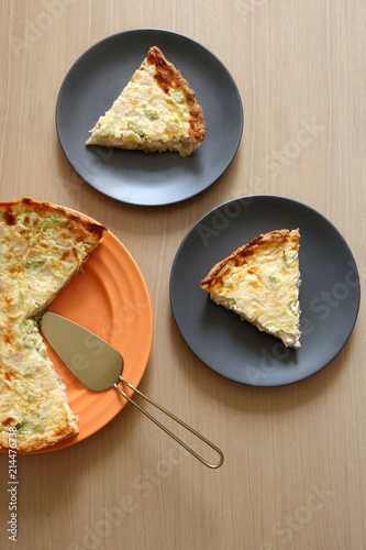 Quiche lorraine with ham, cheeese, broccoli and leek. Two cut slices. Top view. photo