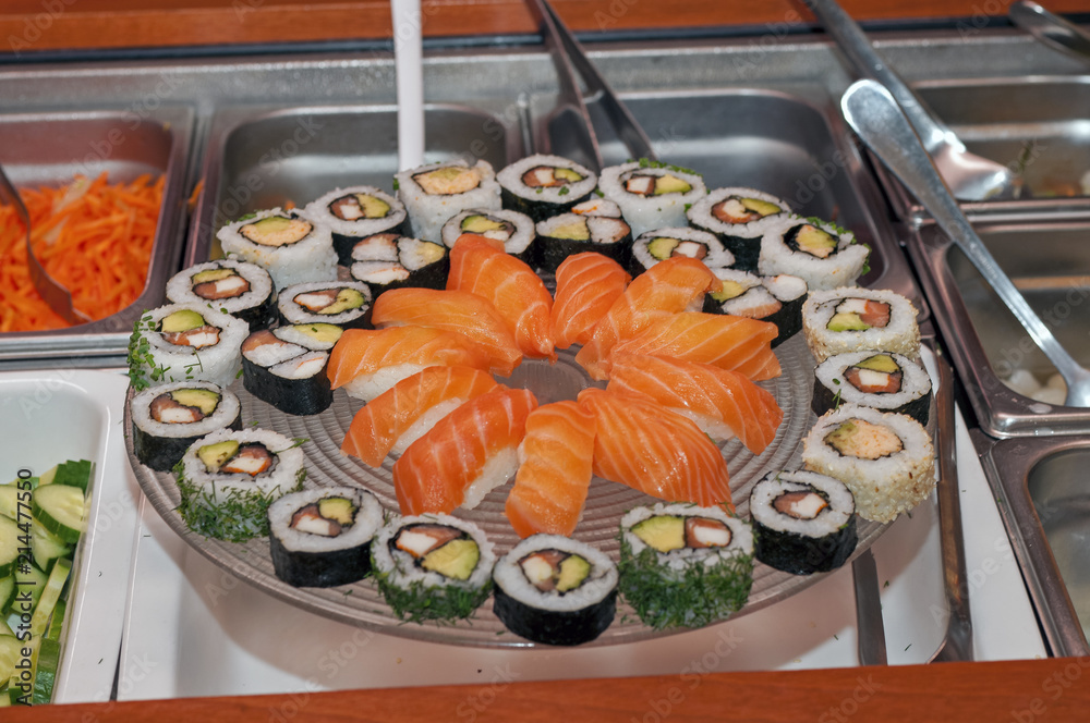 A big glass plate full of sushi A big glass plate full of sushi