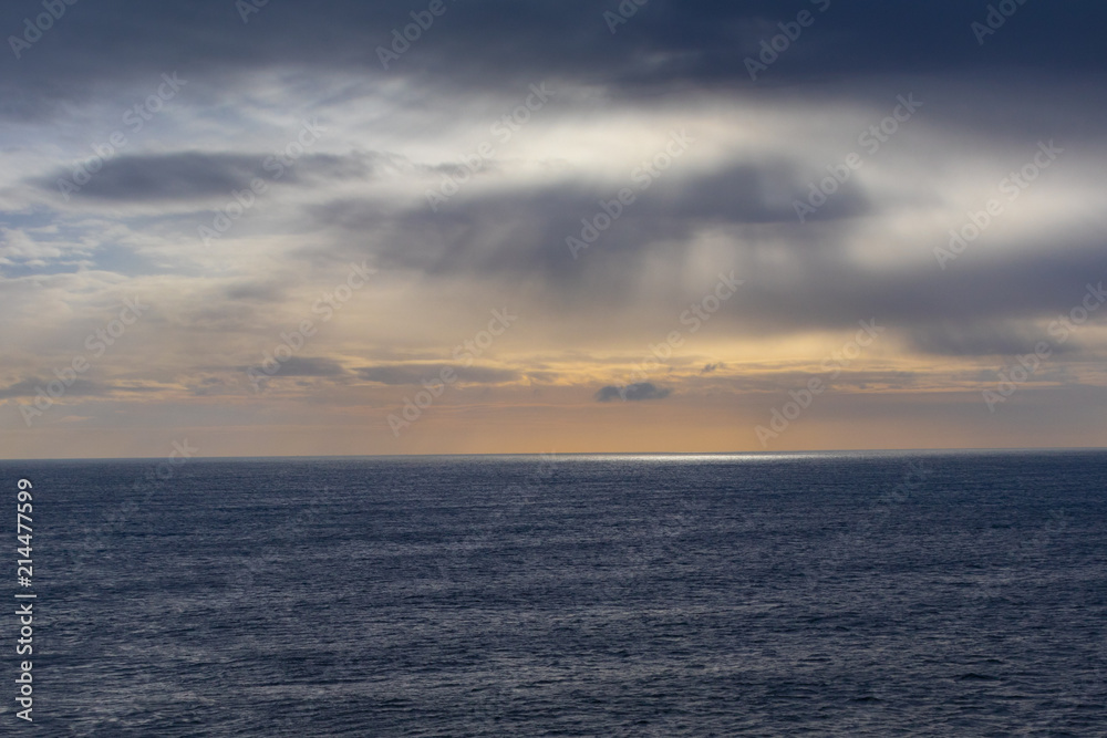 Sunset at sea on a cloudy day
