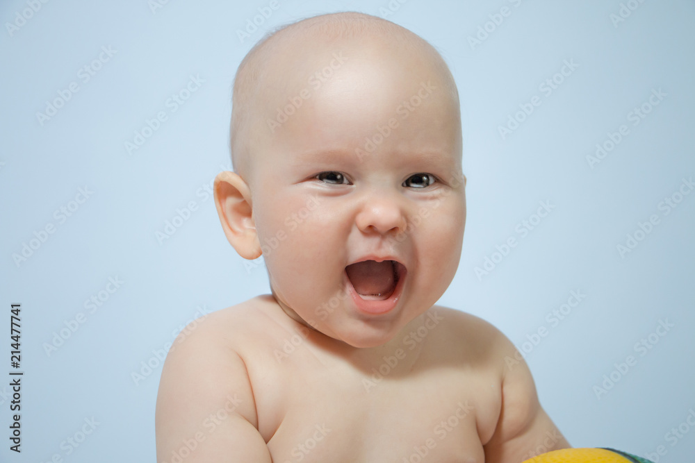 chest portrait of laughing baby close-up on a uniform background chest portrait of laughing baby close-up on a uniform background