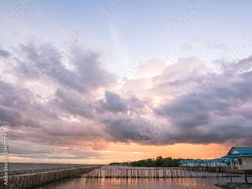 The sky is covered with clouds floating over the seaside.