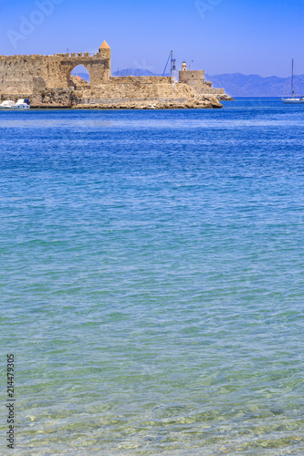 Akti sachtouri beach with Nailac tower on sea in Rhodes old town, Dodecanese, Greece photo