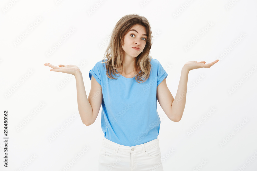 Who knows, I do not care. Portrait of feminine good-looking european female in casual outfit, shrugging with raised spread palms, smiling broadly, having no idea what happening, unaware how answer Who knows, I do not care. Portrait of feminine good-looking european female in casual outfit, shrugging with raised spread palms, smiling broadly, having no idea what happening, unaware how answer