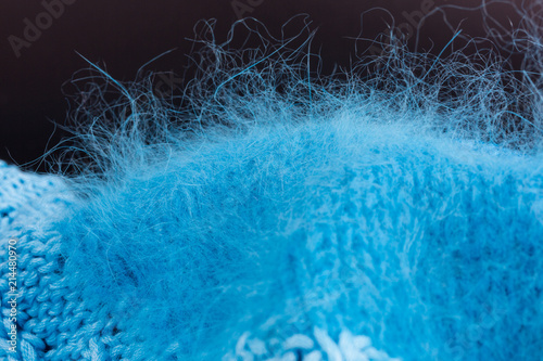 turquoise angora knitting against black background photo