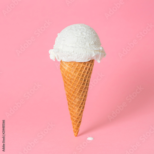 summer funny creative concept of wafer cone with melting ice cream on pink background, copy space