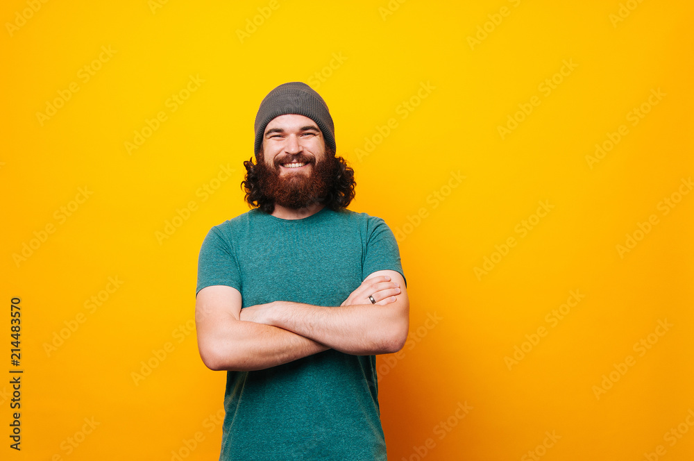 Cheerful smiling bearded hipster man looking confident at the camera Cheerful smiling bearded hipster man looking confident at the camera