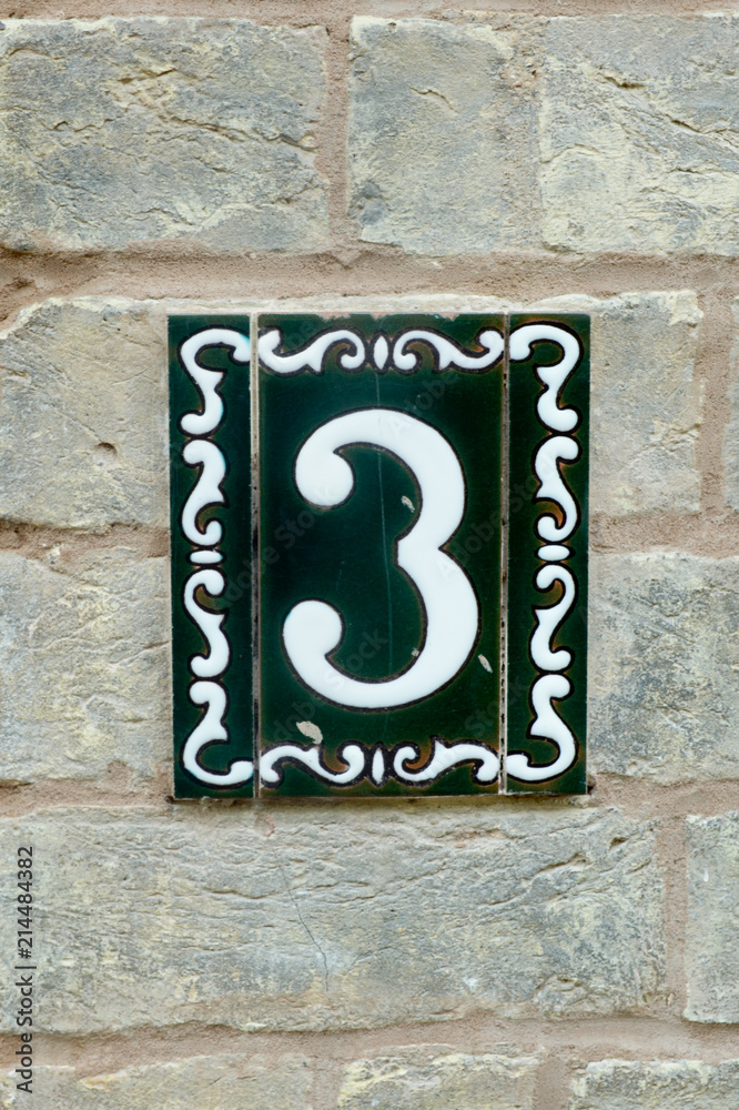 House number 3 sign in ceramic tiles on wall House number 3 sign in ceramic tiles on wall