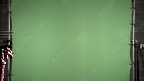 Slow motion red blood mist from a spray bottle on green screen for use with visual effects and or design and texturing. Viewed sideways. photo