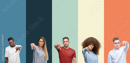 Group of people over vintage colors background looking unhappy and angry showing rejection and negative with thumbs down gesture. Bad expression. photo