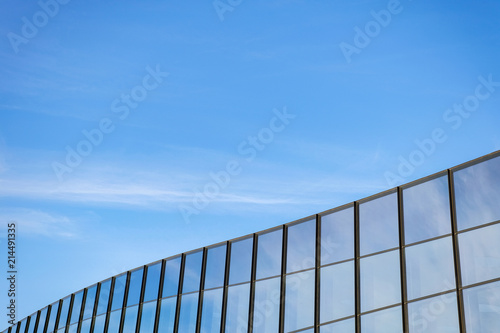 Modern building with large windows against the blue sky.