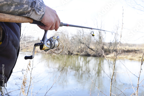 A fisherman catches a fish. Spinning reel closeup. Shallow depth of field on the spinning reel