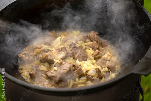 Cooking mutton meat with onion for pilaf