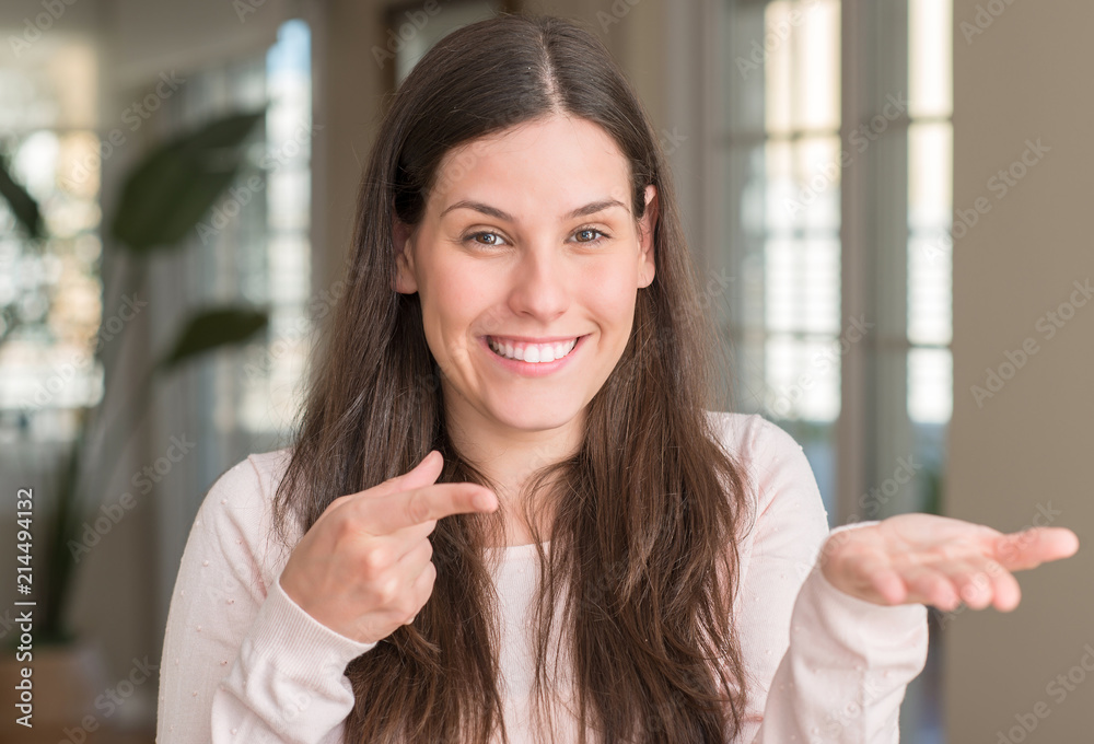 Young beautiful woman at home very happy pointing with hand and finger Young beautiful woman at home very happy pointing with hand and finger