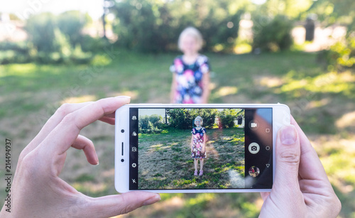 young woman using digital tablet, phone  in park