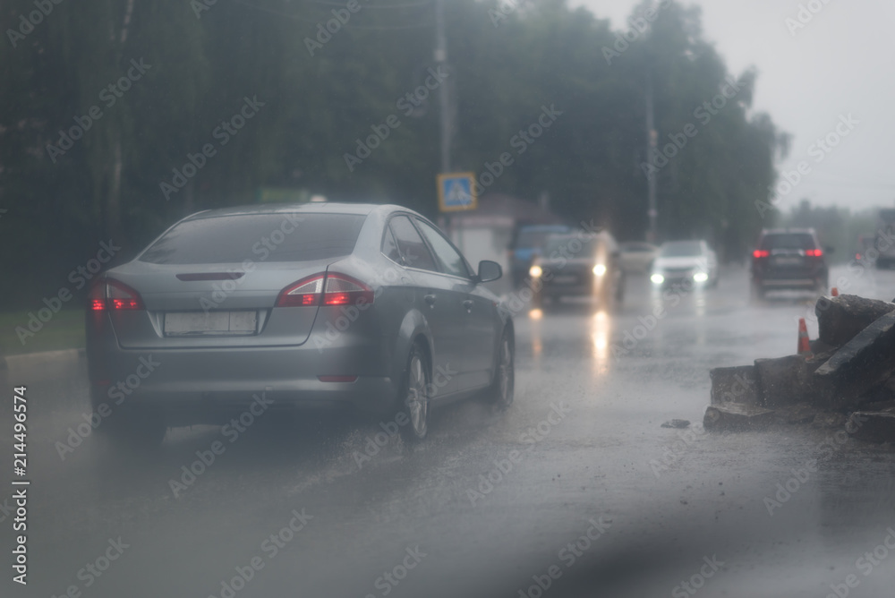 Car splashes trough water on a partly flooded road. Car splashes trough water on a partly flooded road.