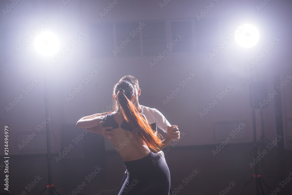 Young couple dancing social danse kizomba or bachata or semba or taraxia in dancing class background Young couple dancing social danse kizomba or bachata or semba or taraxia in dancing class background