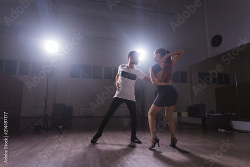 Young couple dancing latin dance Bachata, merengue, salsa. Two elegance pose in dance class