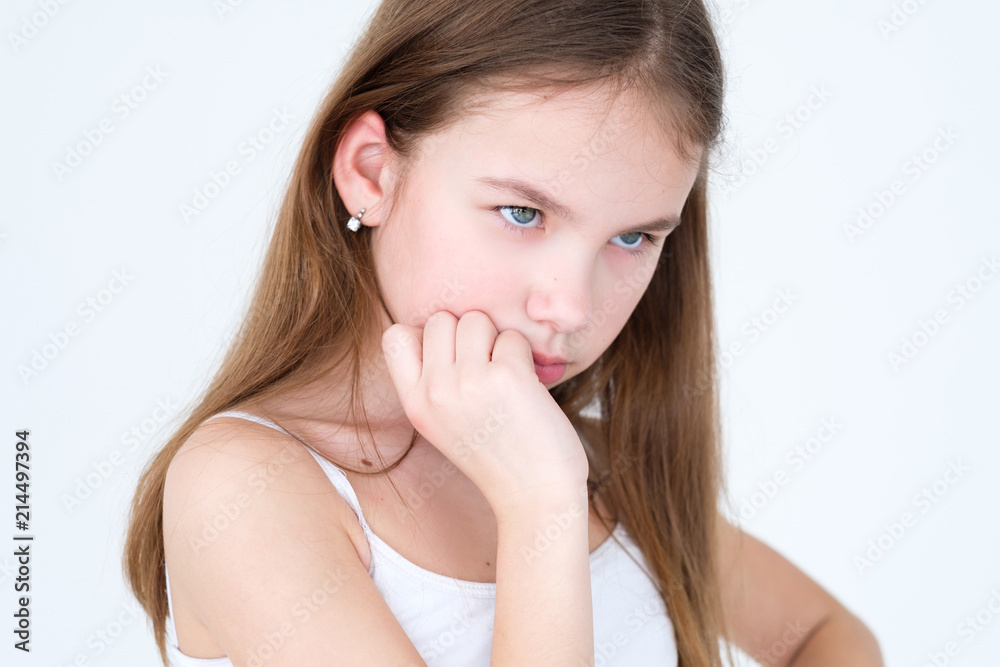 emotion thoughtful face expression. pensive child. little girl portrait on white background. mood feelings personality and facial expression concept