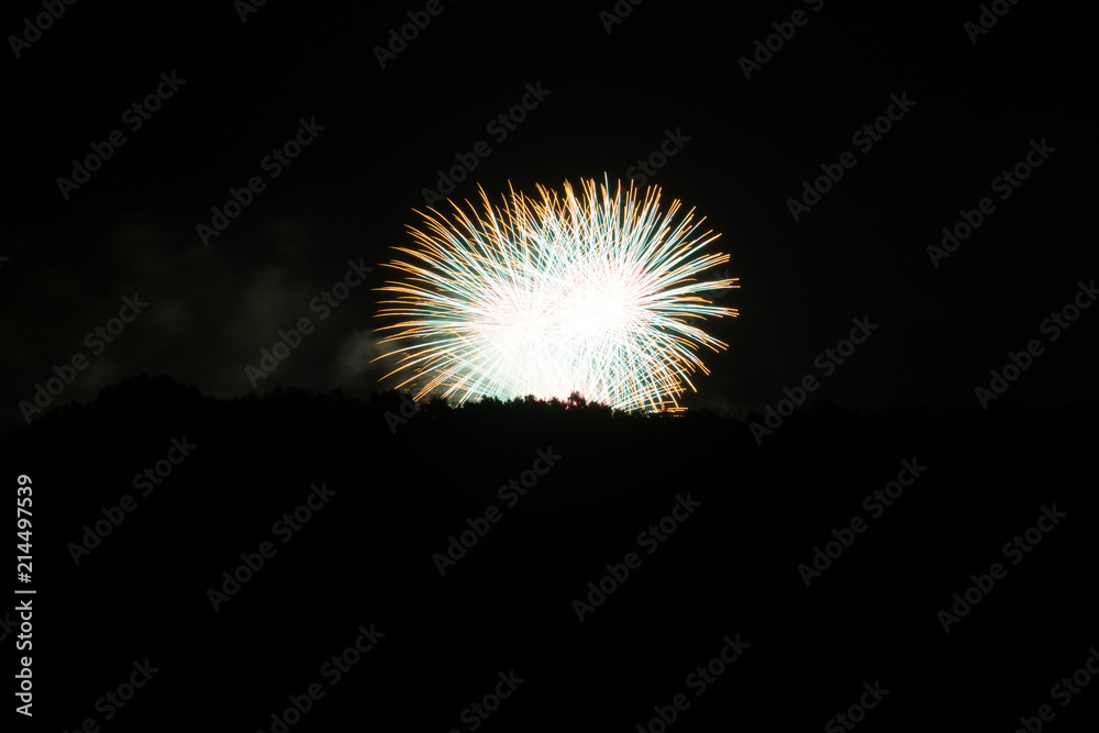 Exploding white and yellow fireworks fireball at amazing celebration in the night Exploding white and yellow fireworks fireball at amazing celebration in the night
