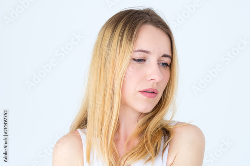 emotion face. thoughtful wistful pensive sad woman. young beautiful blond girl portrait on white background.