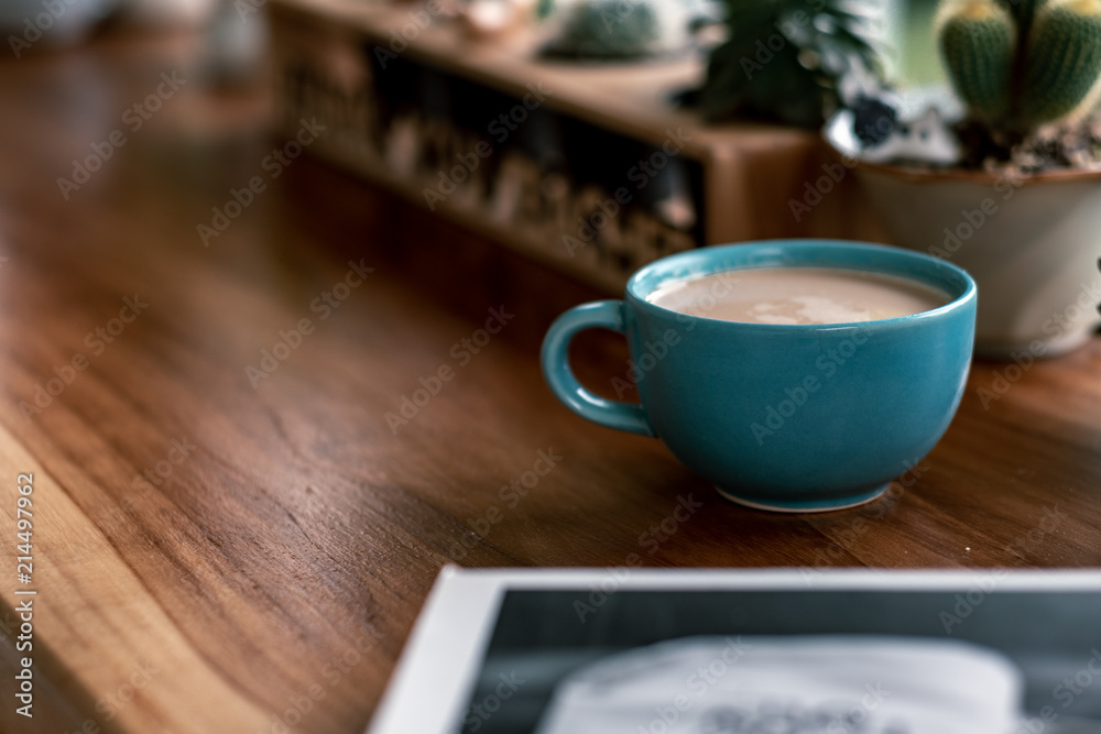 hot coffee cup with cactus on pottery decoration objects.hot coffee mug on white table.