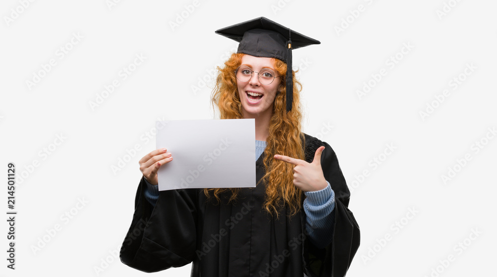 Young redhead woman wearing graduate uniform holding degree very happy pointing with hand and finger Young redhead woman wearing graduate uniform holding degree very happy pointing with hand and finger