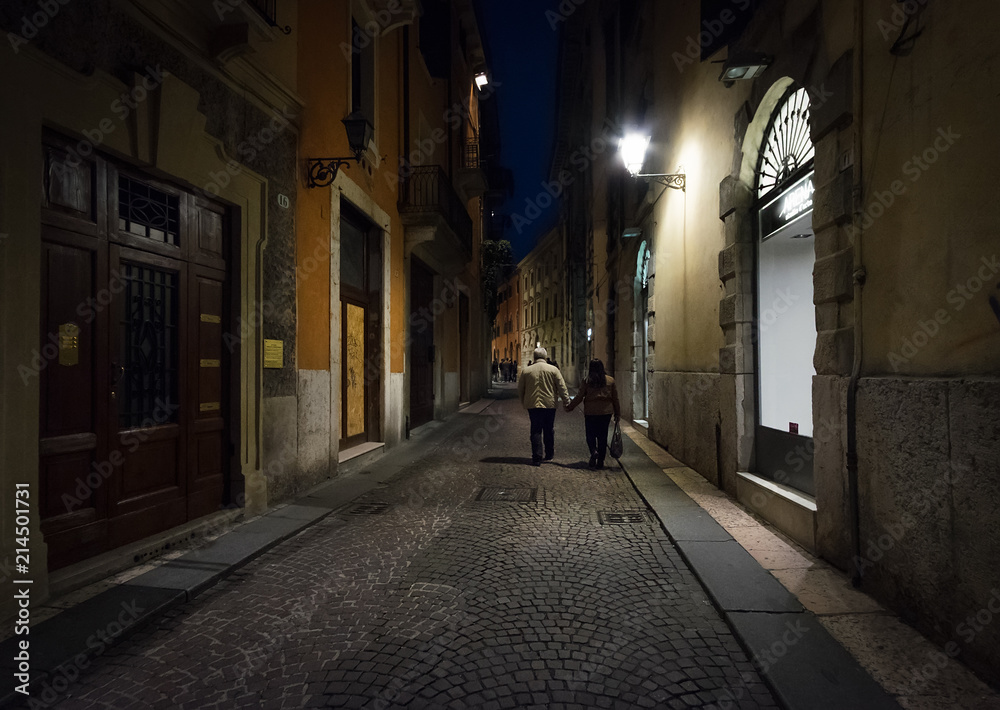 Walking through the streets of night Verona. Italy.