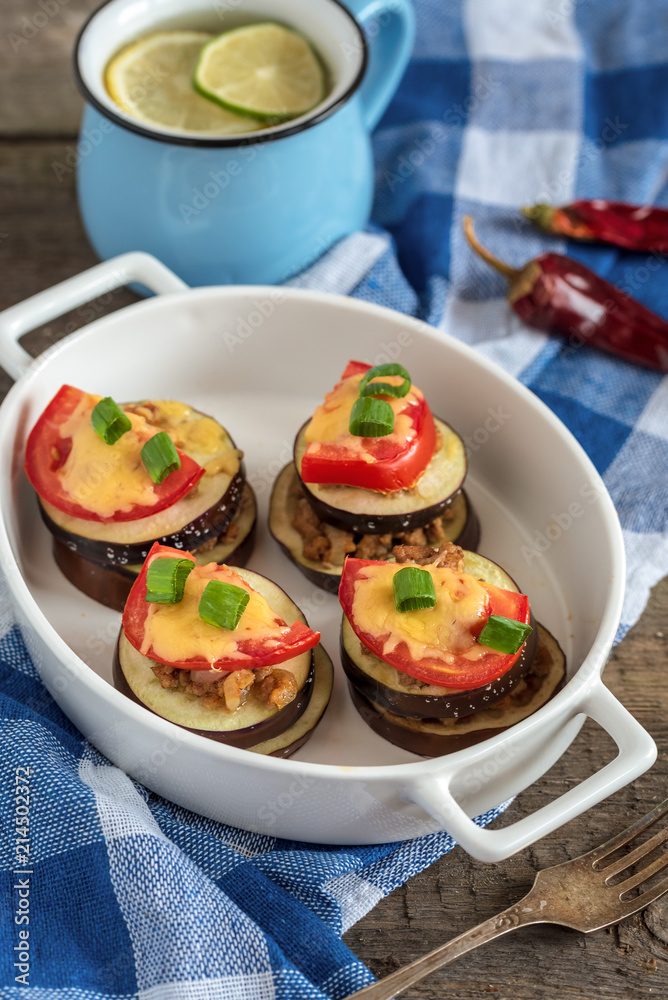 Slices of eggplant baked with minced meat, tomatoes and cheese. Slices of eggplant baked with minced meat, tomatoes and cheese.
