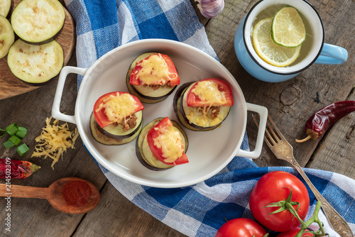 Slices of eggplant baked with minced meat, tomatoes and cheese.