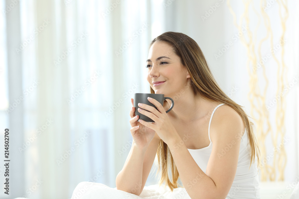 Relaxed girl waking up having breakfast on the bed Relaxed girl waking up having breakfast on the bed
