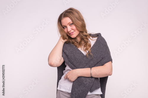 Beautiful girl with hand in curly hair, wearing cardigan