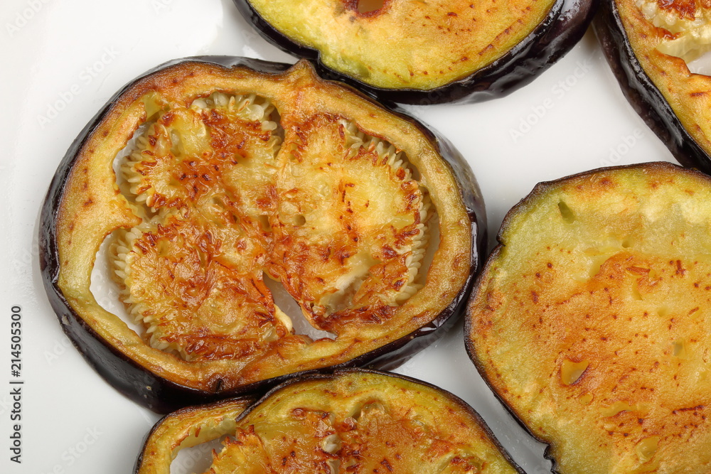 Sliced roasted eggplants in a white plate Sliced roasted eggplants in a white plate