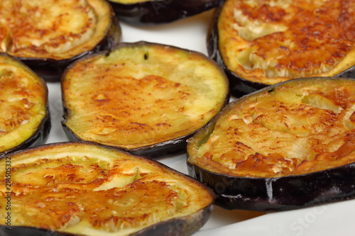 Sliced roasted eggplants in a white plate