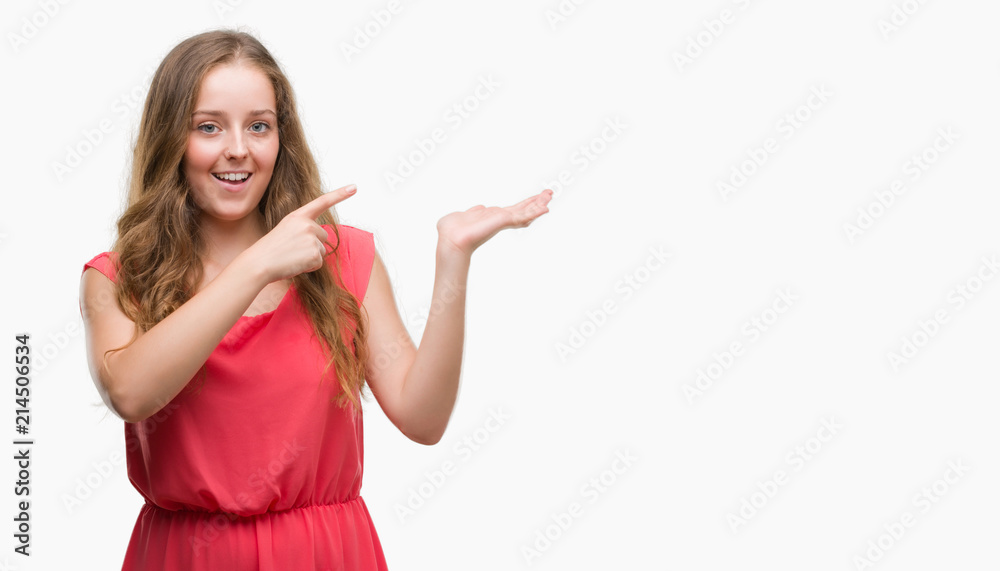 Obraz premium Young blonde woman wearing pink dress very happy pointing with hand and finger