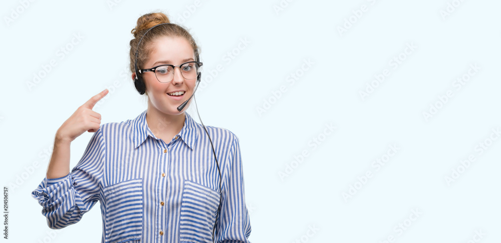Young blonde call center operator woman very happy pointing with hand and finger Young blonde call center operator woman very happy pointing with hand and finger
