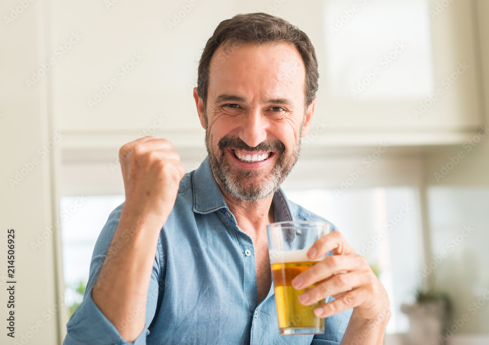 Middle age man drinking beer screaming proud and celebrating victory and success very excited, cheering emotion Middle age man drinking beer screaming proud and celebrating victory and success very excited, cheering emotion