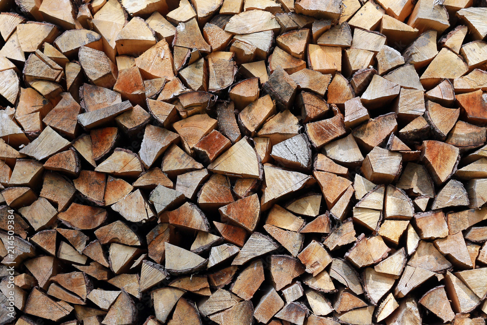 Firewoods stack at the wall background with a text space design pattern Firewoods stack at the wall background with a text space design pattern