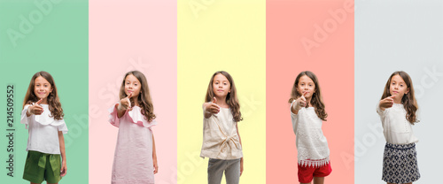 Collage of brunette hispanic girl wearing different outfits smiling friendly offering handshake as greeting and welcoming. Successful business.