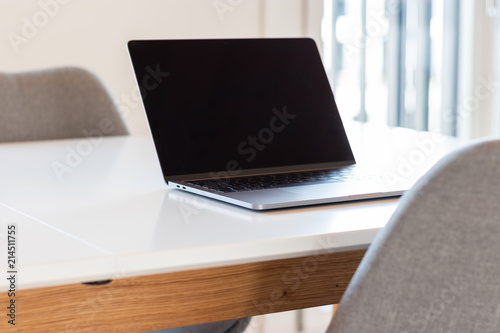 open laptop on white desk