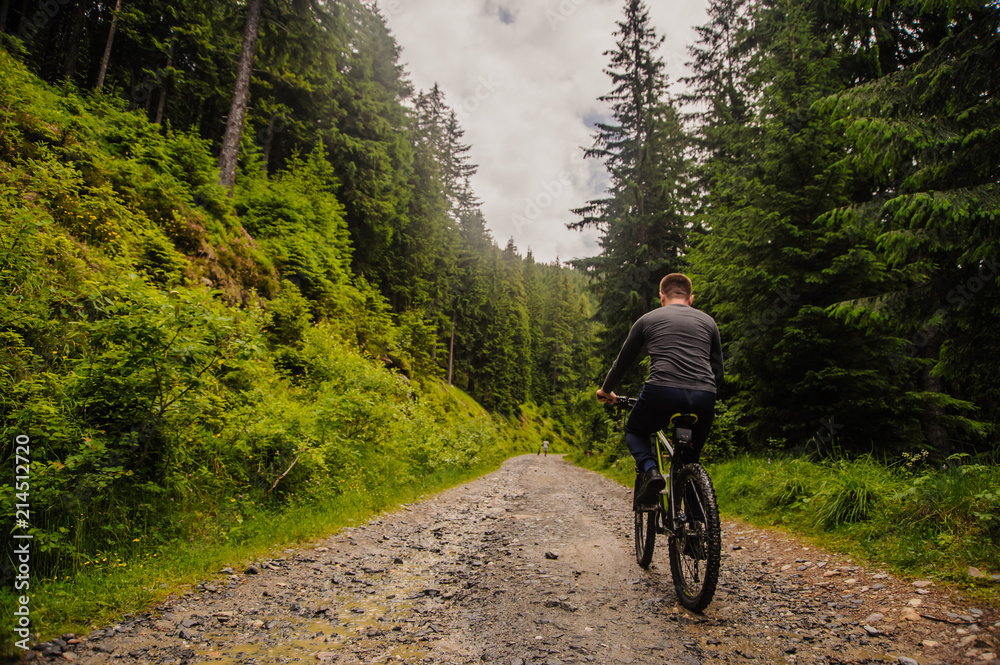 A handsome man on a bicycle