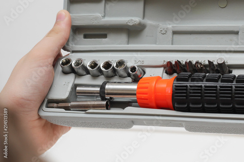 Master is holding a set of screwdrivers in a box on a white background.