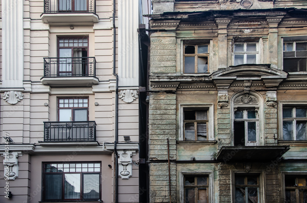 Fototapeta premium An old and new, modern building next to an ancient dilapidated building.