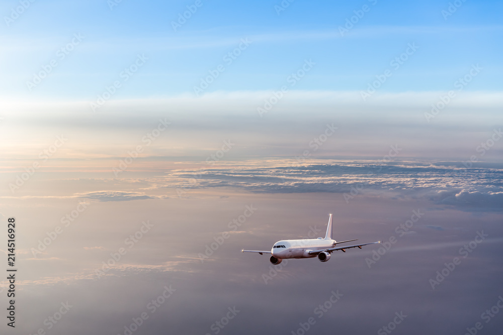 Commercial airplane flying above dramatic clouds. Commercial airplane flying above dramatic clouds.