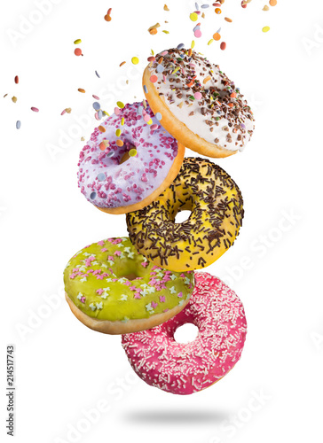 Tasty doughnuts in motion falling on white background.